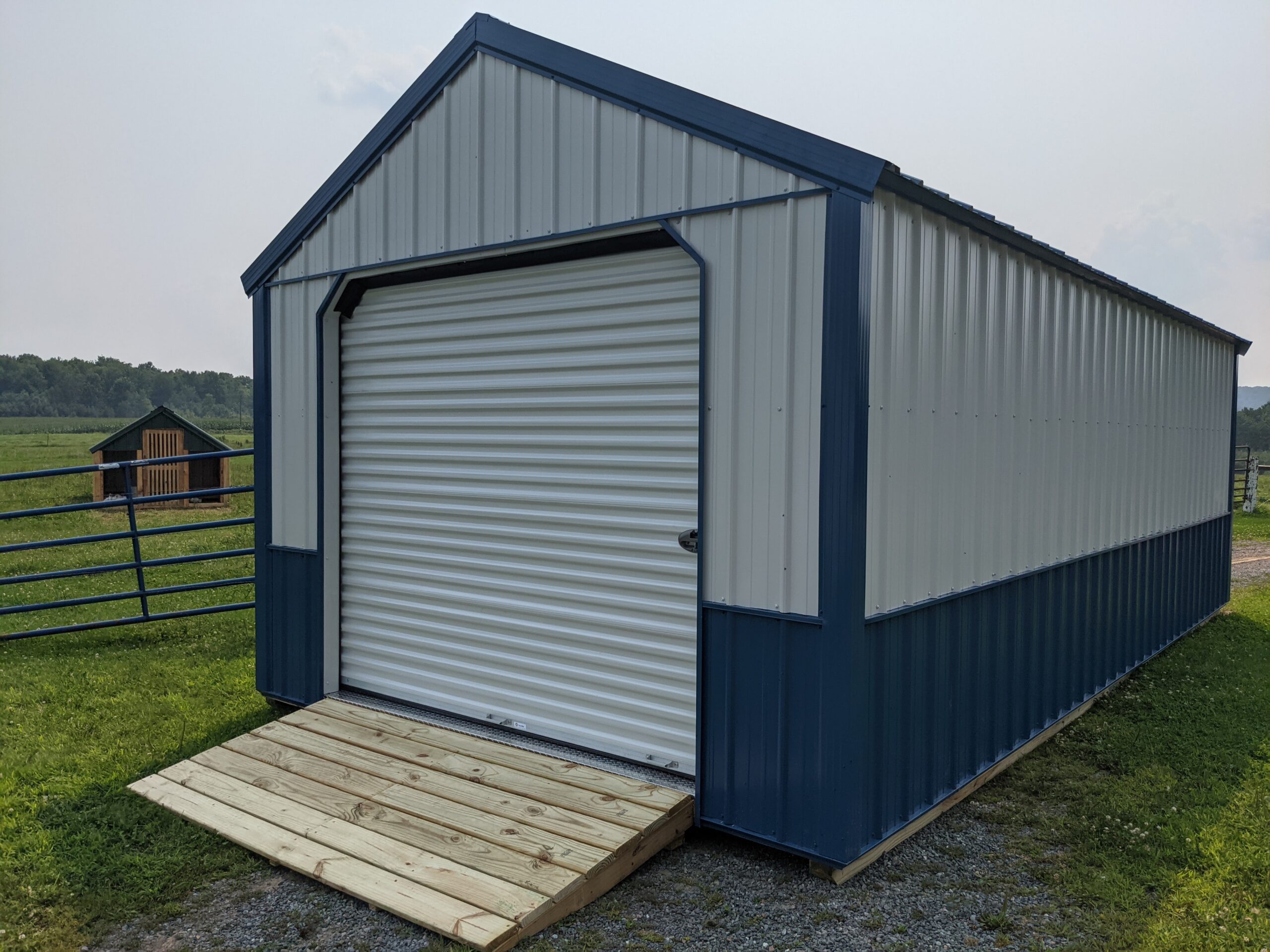 12x24 Metal A-frame white/blue with 8x7 Roll Up Door - Sheds Delivered |  Barns | Cabins | Garages & More