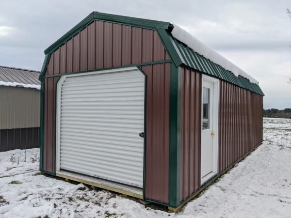 12x30 lofted garage earth brown siding - green trim 8x7 white rollup door